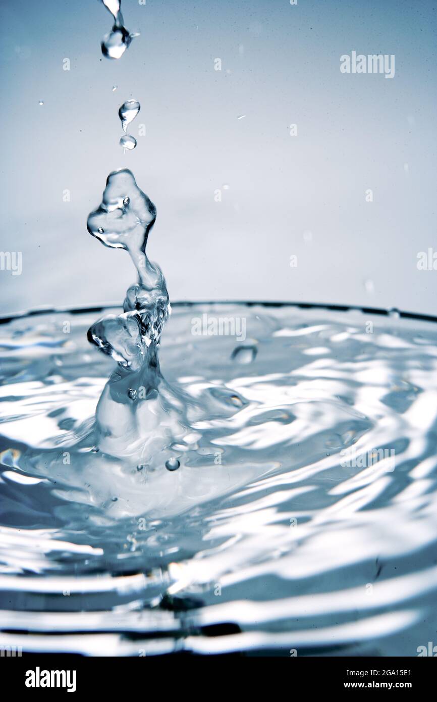 Splashing water with drops. Splash. Water drops, fresh water. Basic elements of environment. Freshness in nature. Clean drinking water on Earth. Stock Photo