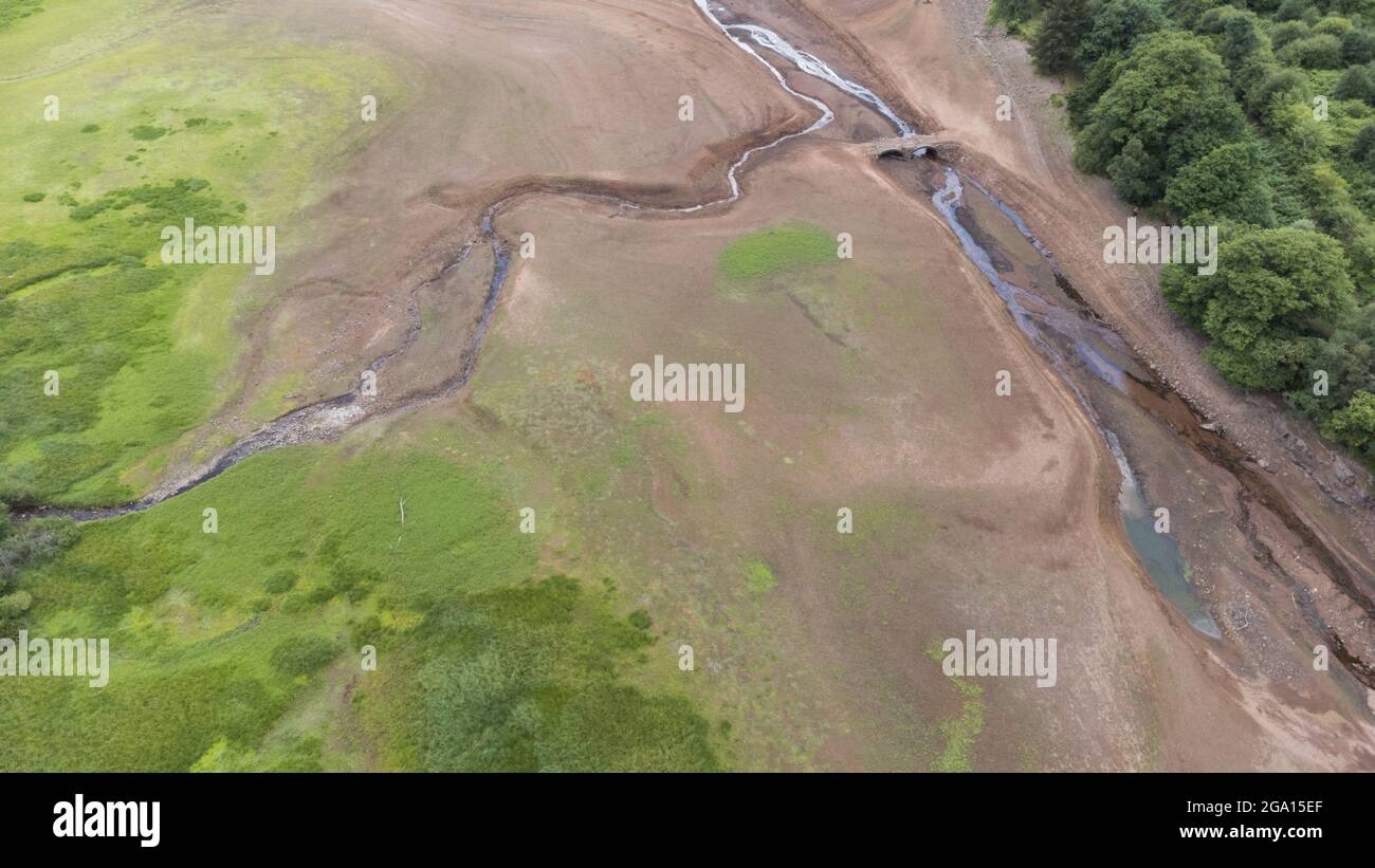 Llwyn Onn reservoir, Merthyr Tydfil, South Wales. 28 July 2021. Water levels remain low at the reservoir after the heatwave. Credit: Andrew Bartlett/Alamy Live News. Stock Photo