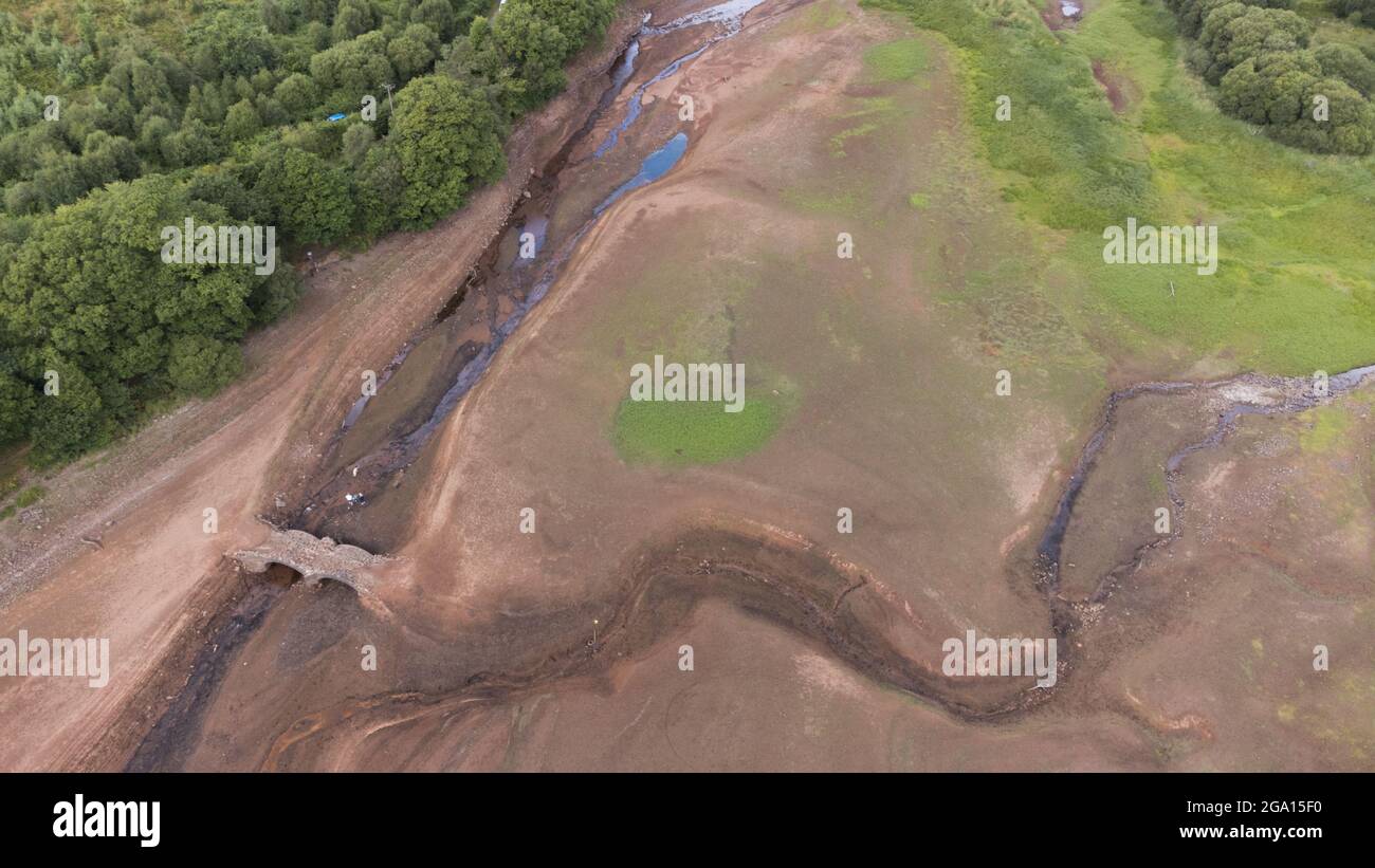Llwyn Onn reservoir, Merthyr Tydfil, South Wales. 28 July 2021. Water levels remain low at the reservoir after the heatwave. Credit: Andrew Bartlett/Alamy Live News. Stock Photo