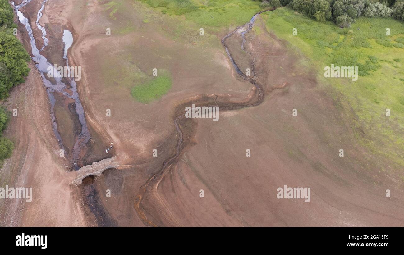 Llwyn Onn reservoir, Merthyr Tydfil, South Wales. 28 July 2021. Water levels remain low at the reservoir after the heatwave. Credit: Andrew Bartlett/Alamy Live News. Stock Photo