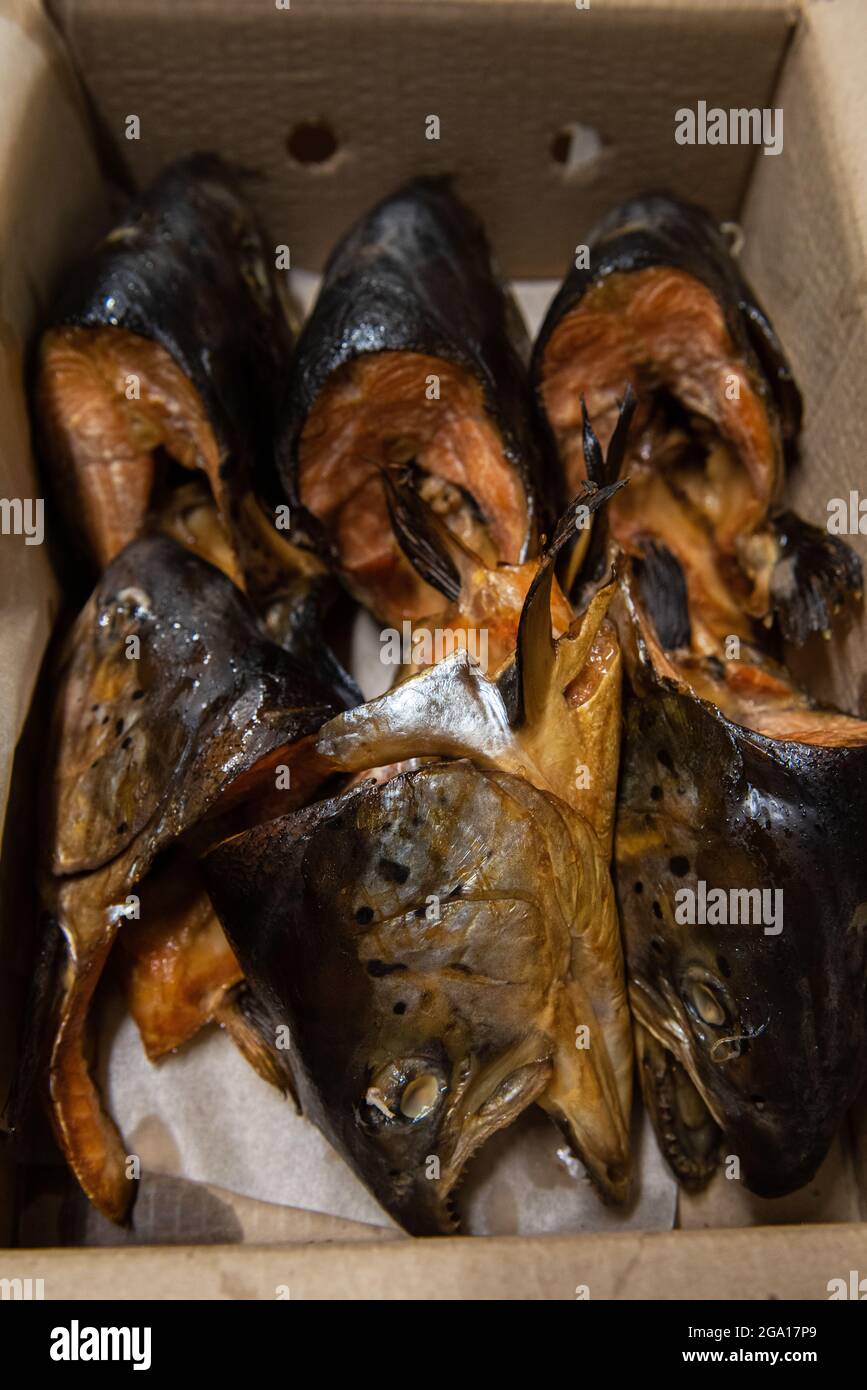 Smoked fish in craft paper box. Ready for delivery production. Smoked fish production concept