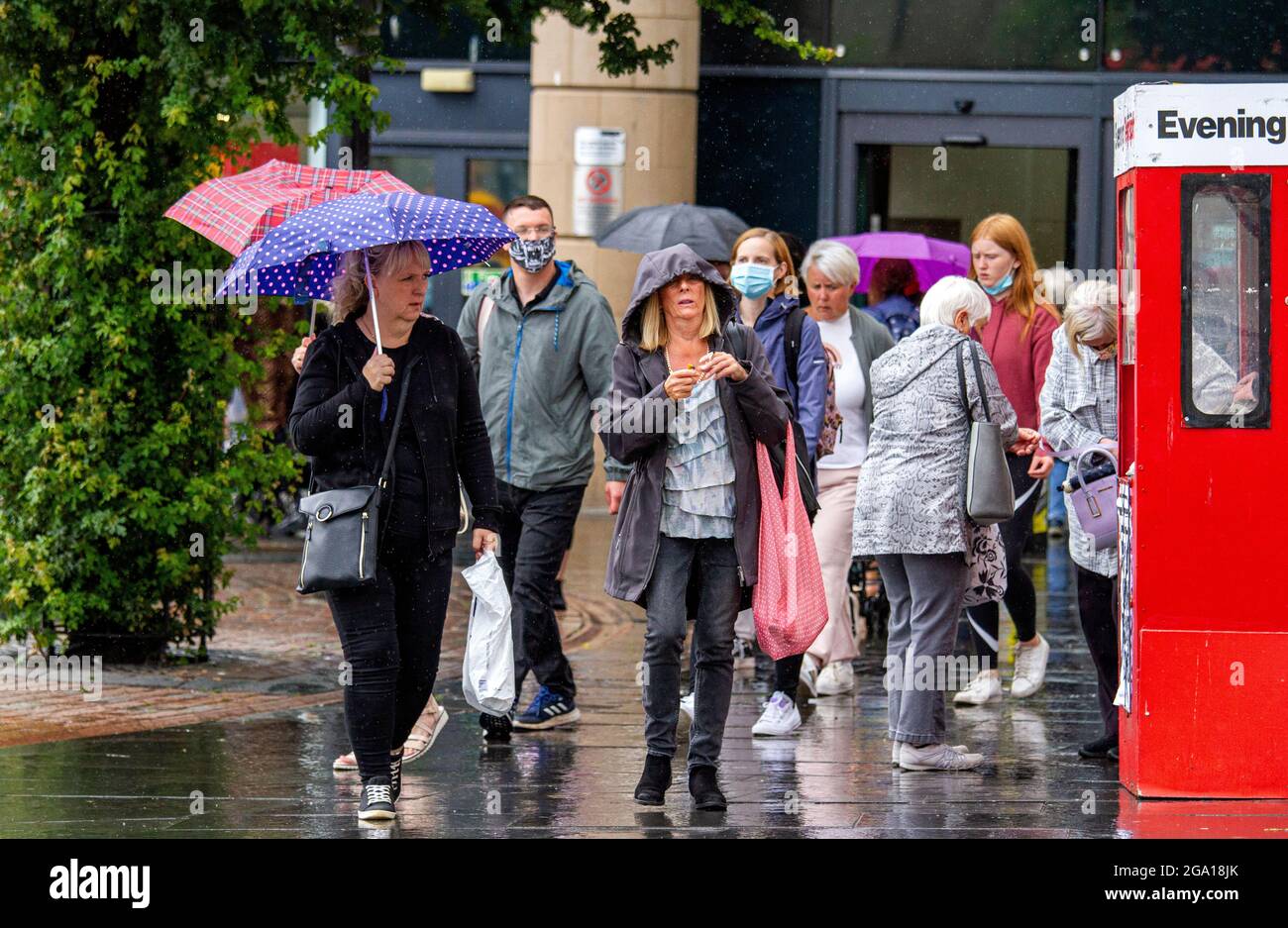 Dundee, Tayside, Scotland, UK. 28th July, 2021. UK Weather: Humid and overcast day with outbreaks of heavy rain across North East Scotland with temperatures reaching 21°C. Local residents are caught out in sudden outbursts of heavy rain whilst out shopping in Dundee city centre. Credit: Dundee Photographics/Alamy Live News Stock Photo