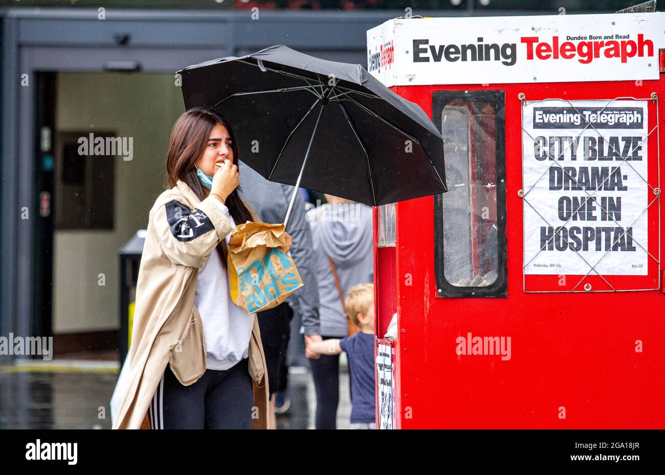 Dundee, Tayside, Scotland, UK. 28th July, 2021. UK Weather: Humid and overcast day with outbreaks of heavy rain across North East Scotland with temperatures reaching 21°C. Local residents are caught out in sudden outbursts of heavy rain whilst out shopping in Dundee city centre. Credit: Dundee Photographics/Alamy Live News Stock Photo