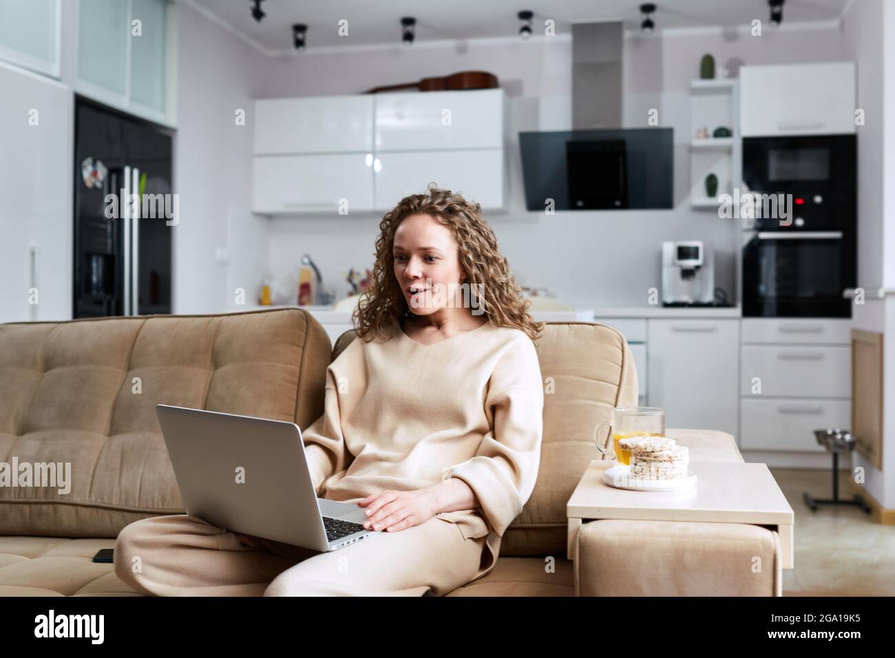 Head shot pleasant happy young woman freelancer working on computer at home. Attractive businesswoman studying online, using laptop software, web surf Stock Photo