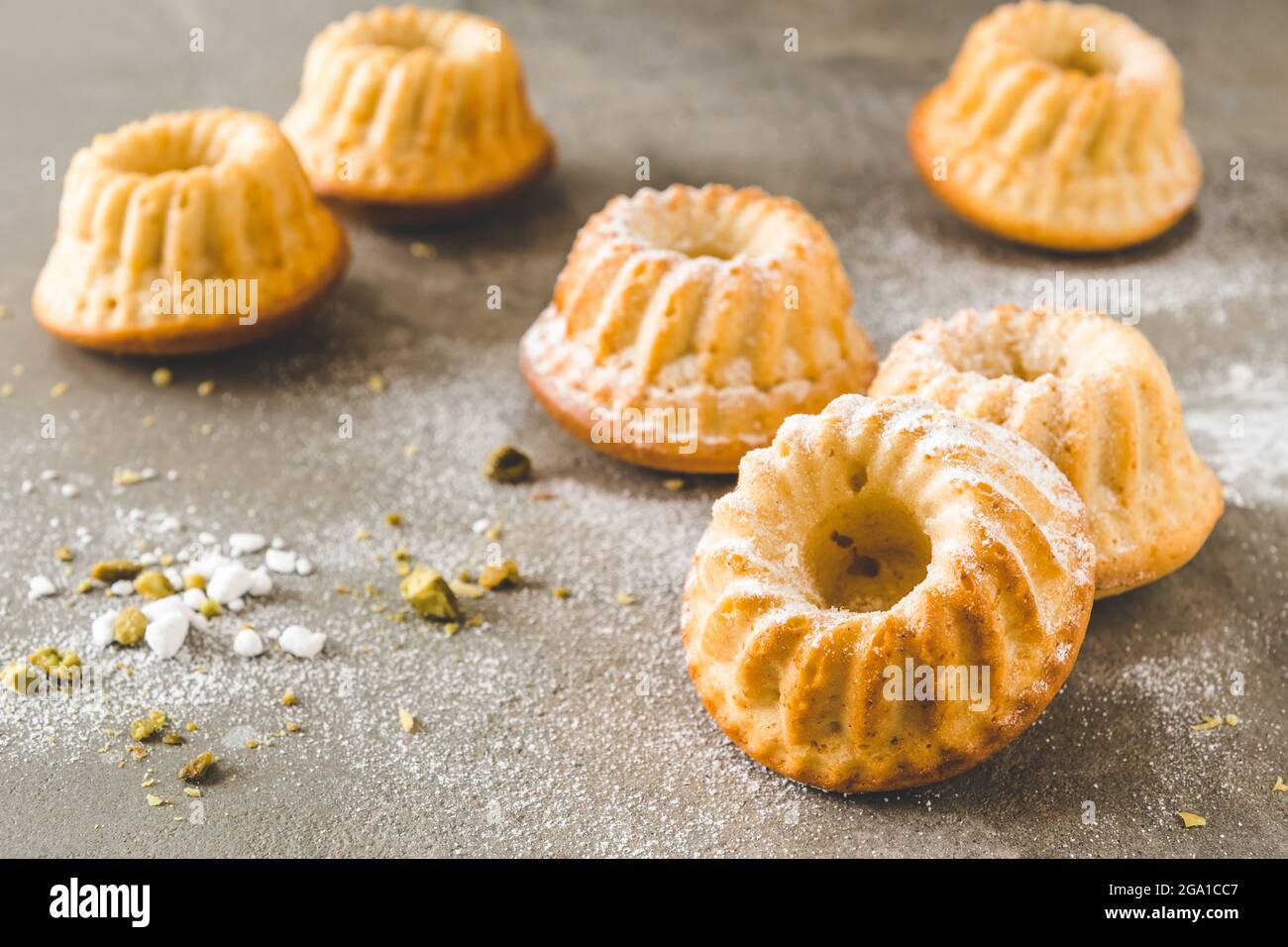 Homemade delicious mini lemon bundt cakes (muffins) on gray concrete background Stock Photo