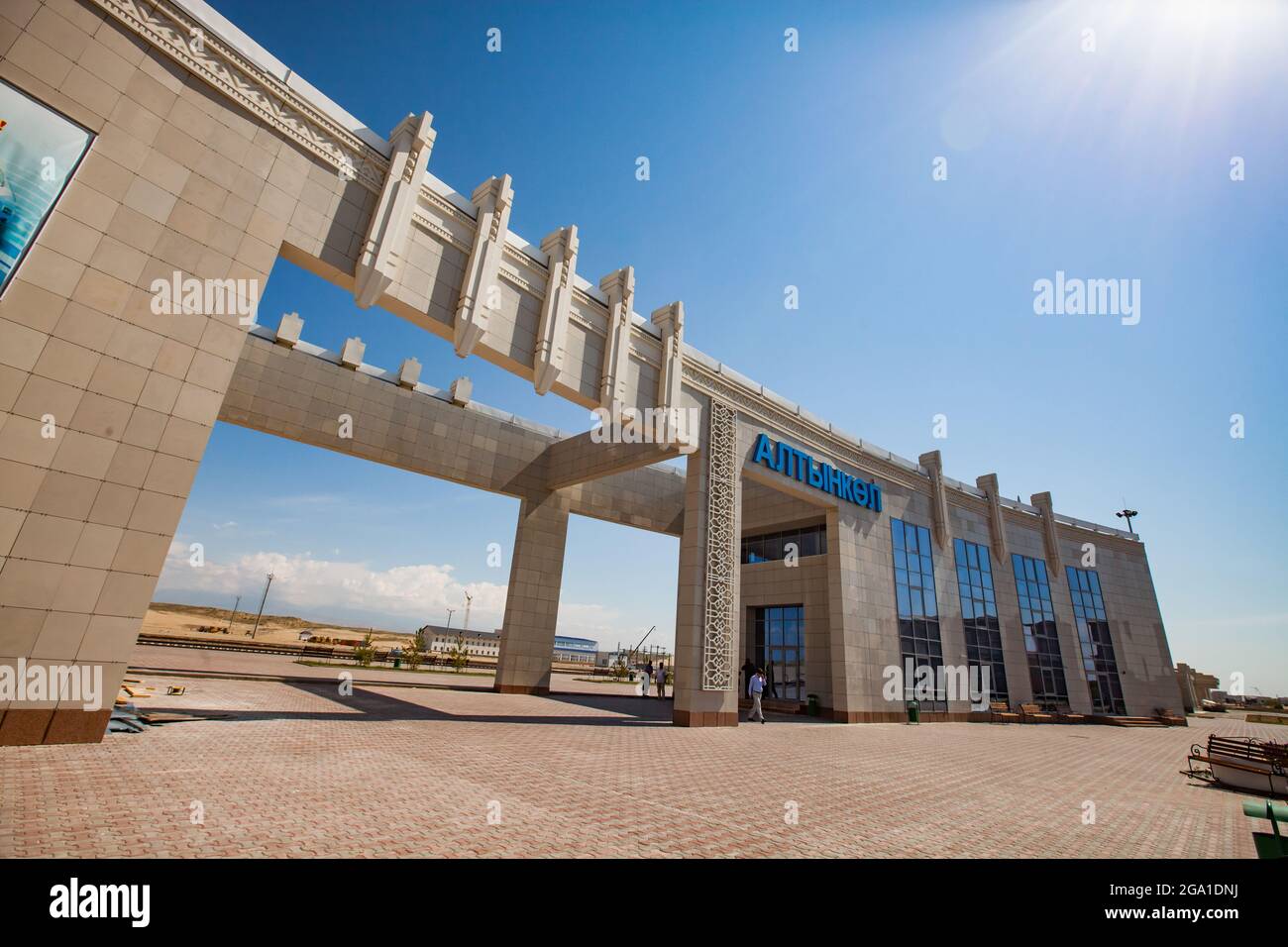 Altynkol, Kazakhstan - June 05, 2012: Railway station Altynkol. Down up panoramic view on building. Paving bricks floor. Blue station name letters. Bl Stock Photo