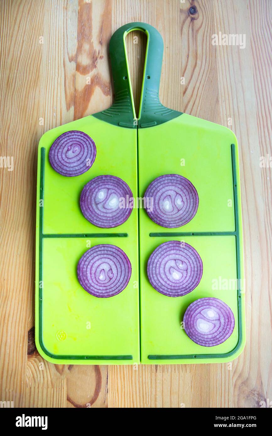 Sliced red onion on a green board Stock Photo