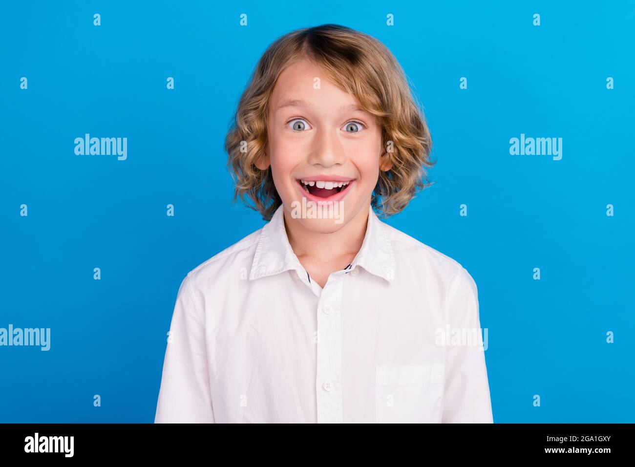 Portrait Of Attractive Amazed Cheerful Boy Great News Reaction Isolated Over Vibrant Blue Color Background Stock Photo Alamy
