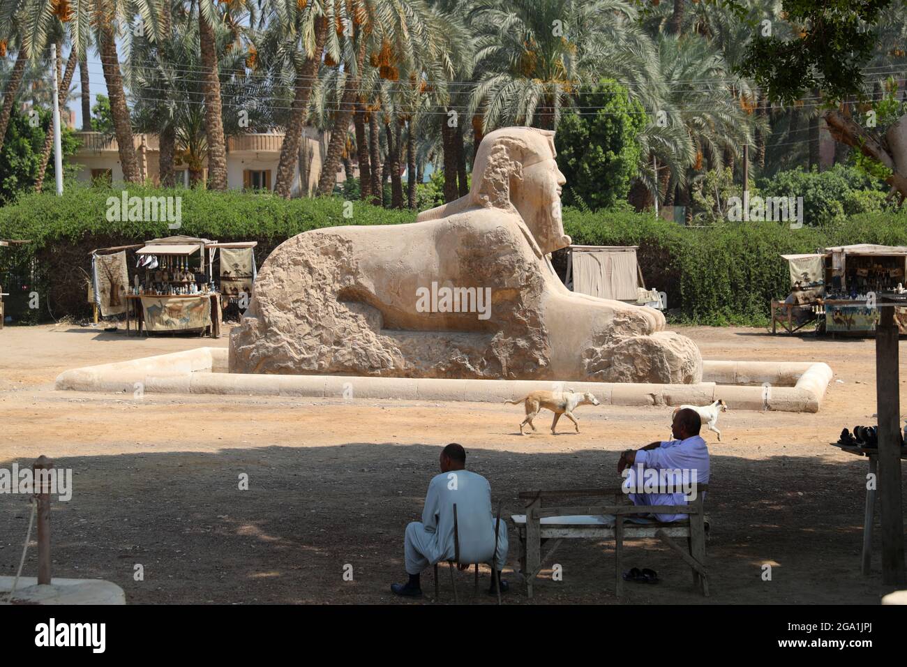 (210728) -- CAIRO, July 28, 2021 (Xinhua) -- Vendors wait for tourists by the statue of Sphinx at the ruins of ancient Egyptian city of Memphis, around 23 kilometers southwest to Cairo, capital of Egypt, July 28, 2021. Memphis, founded around 3,100 BC, was the capital of ancient Egypt during the Old Kingdom spanning from 2700-2200 BC and remained an important city throughout ancient Egyptian history. Today, the ruins of the former capital offer fragmented evidence of its past. Together with its necropolis (the pyramid fields from Giza to Dahshur), Memphis was inscribed as a World Heritage Site Stock Photo