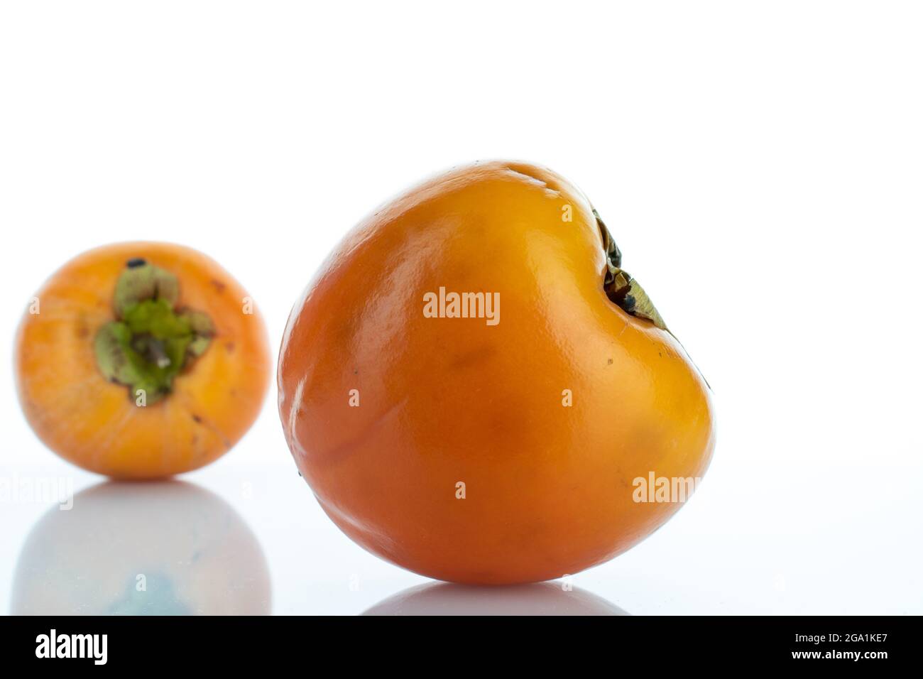 Two ripe organic persimmons, close-up, isolated on white Stock Photo ...