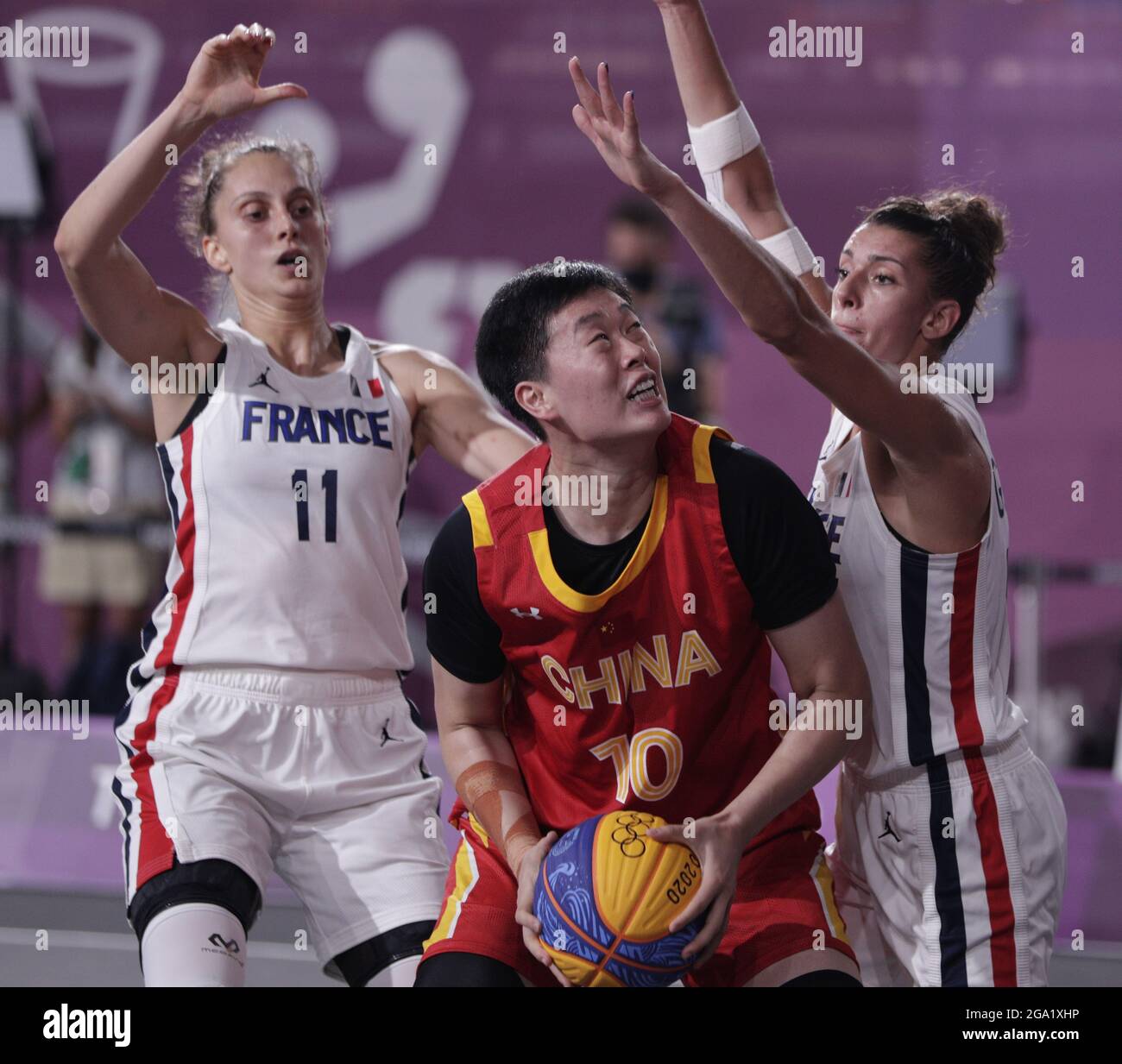 Tokyo, Japan. 28th July, 2021. China's Zhiting Zhang (10) is guarded by Ana Maria Filip of France (11) and Laetitia Guapo during the Women's 3X3 Basketball bronze medal game at the Tokyo Summer Olympics in Tokyo, Japan, on Wednesday, July 28, 2021. China won the game to take the bronze medal. Photo by Bob Strong/UPI. Credit: UPI/Alamy Live News Stock Photo