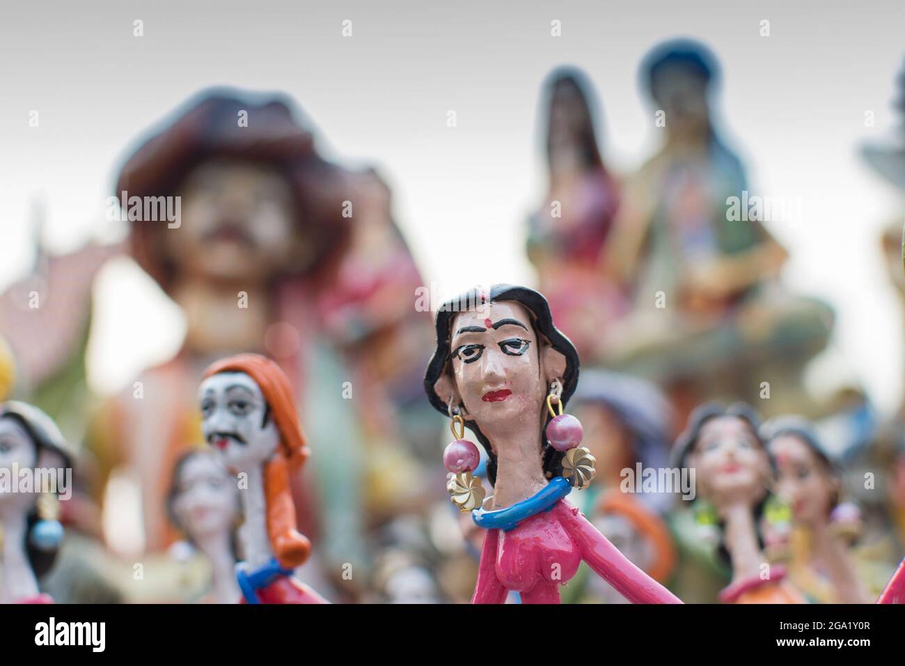 Colorful dolls made of clay, handicrafts on display during the