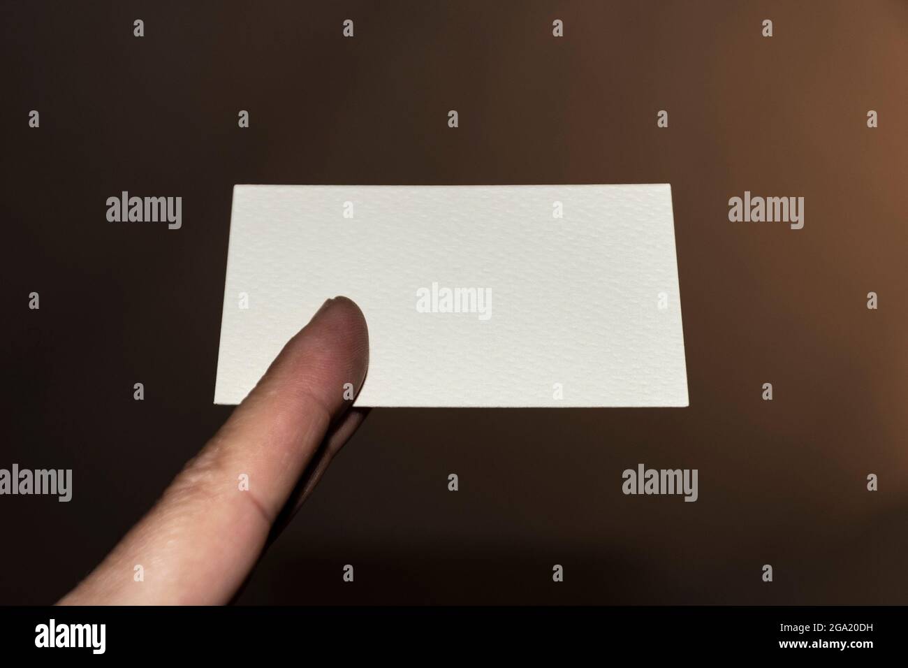 Hand holding a blank business card Stock Photo - Alamy