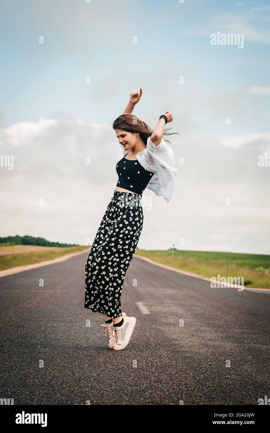 teenager girl dancing on the road. freedom generation z Stock Photo