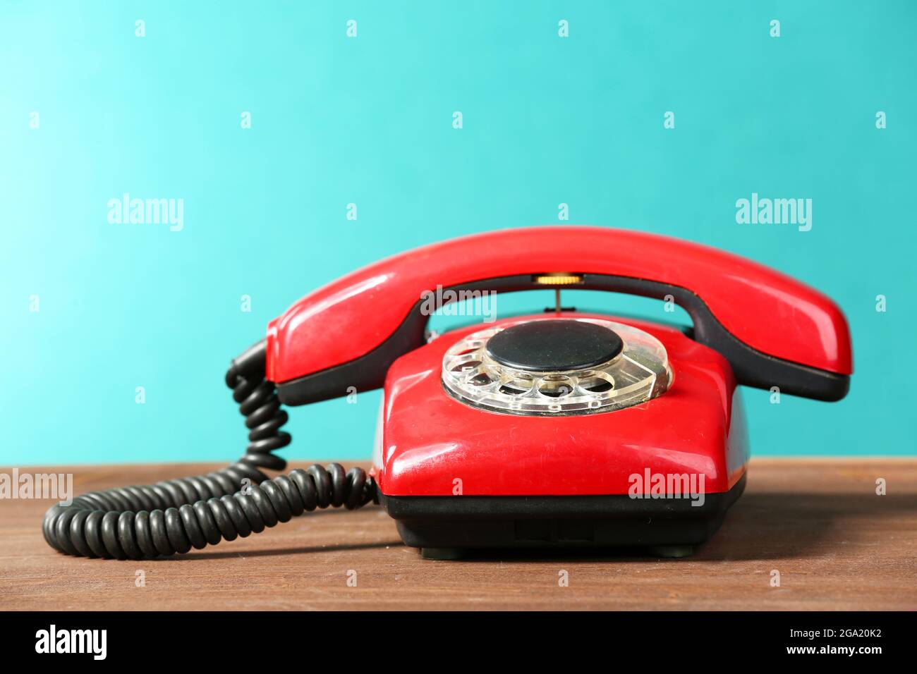 Retro red telephone on table on green background Stock Photo Alamy