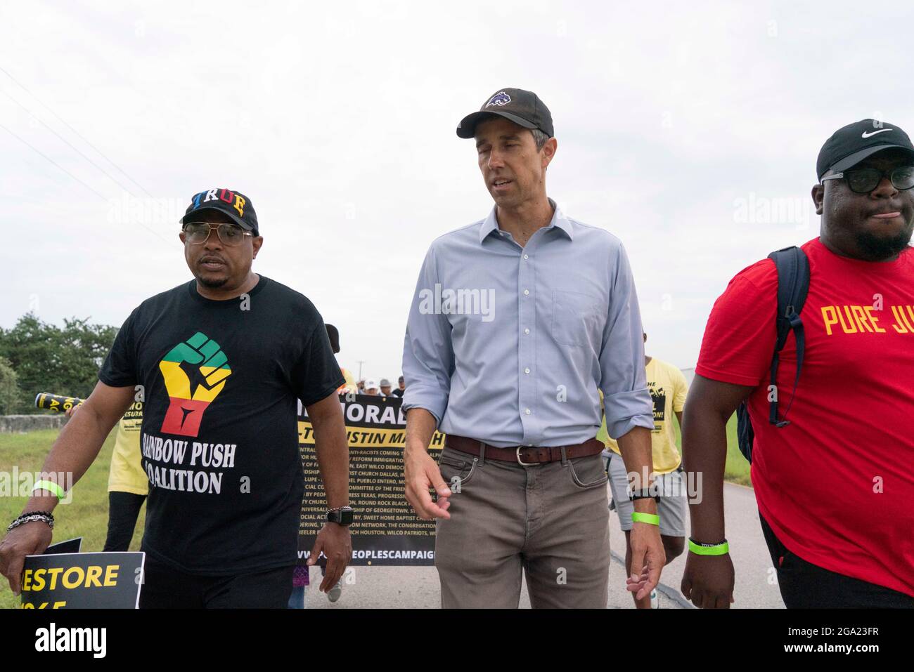 Georgetown, United States. 28th July, 2021. Former congressman and current Democratic activist BETO O'ROURKE (in blue shirt) leads voting rights advocates as they start a 30 mile, four-day march from Georgetown, Texas to the State Capitol in Austin. Due to summer Texas heat, several 100-person shifts will trade off marching about 4 miles each. Credit: Bob Daemmrich/Alamy Live News Stock Photo