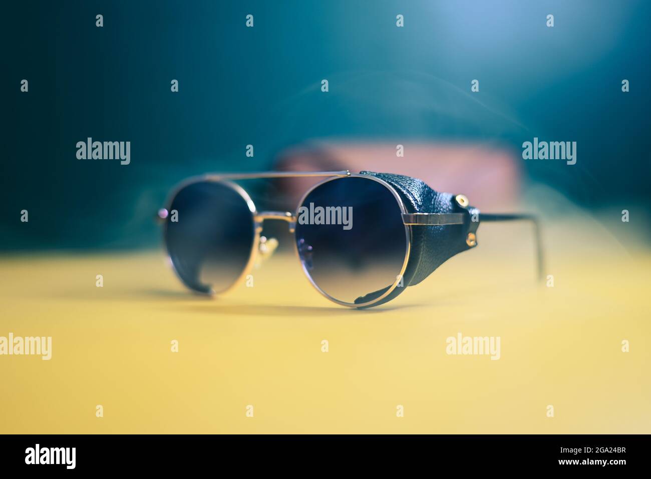 steampunk sunglasses with leather inserts with smoke on dark background Stock Photo