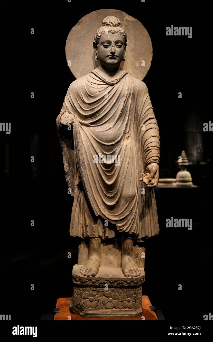 ancient standing Buddha schist statue image in 2nd-3rd century, Kushan dynasty from near Peshawar, Pakistan. Stock Photo