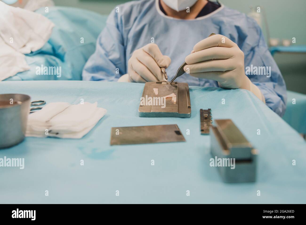 Medical doctor working on rhinoplasty operation inside hospital room - Focus on nurse right hand. Stock Photo
