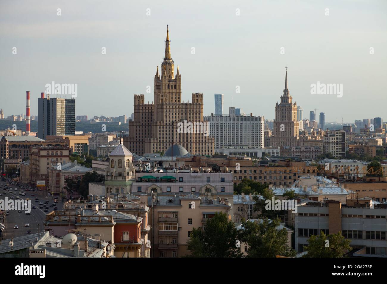 Two Stalinist skyscrapers and White House of Russia. Moscow. Panorama view of city on the blue sky with light haze or smog. Stock Photo