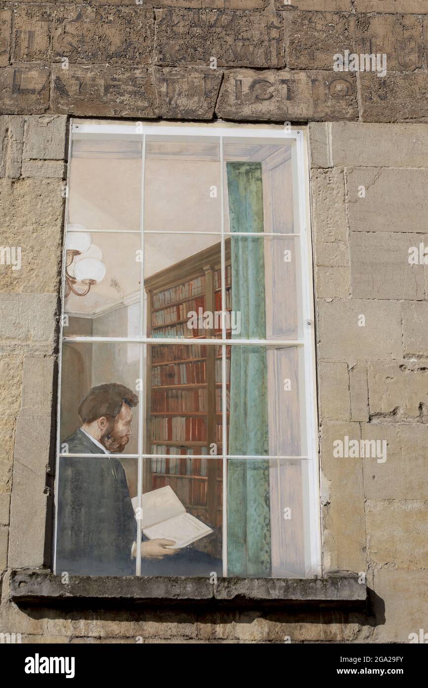 Mural painted on the facade of a house of a man looking at a book in his home library in Bath, England; Bath, Somerset, England Stock Photo