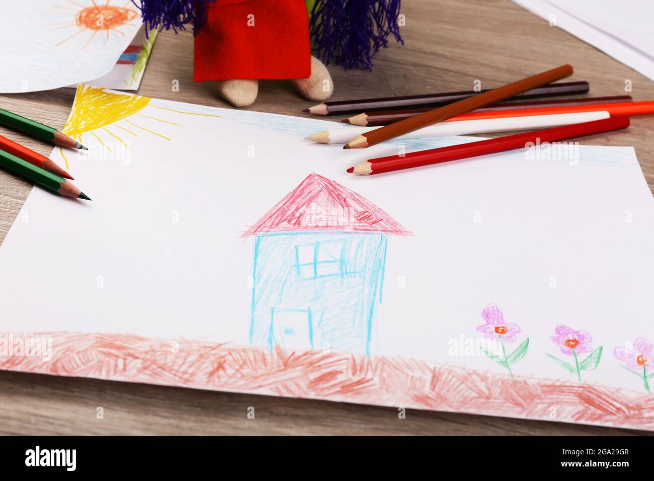 Kids drawing on white sheet of paper with crayon,closeup Stock Photo - Alamy