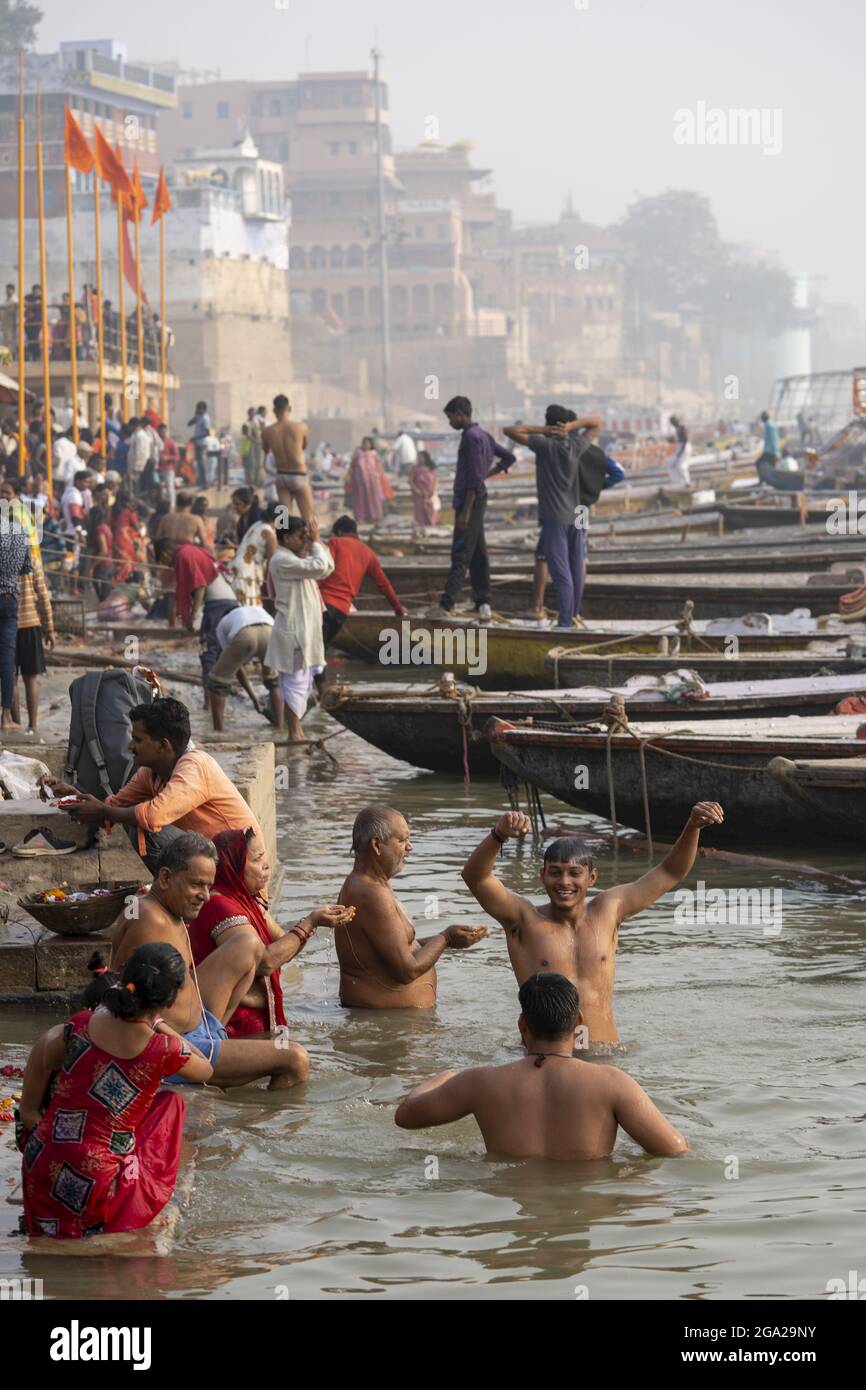 Hindu pilgrims taking morning bath on the bank of the Ganges River; Varanasi, Uttar Pradesh, India Stock Photo