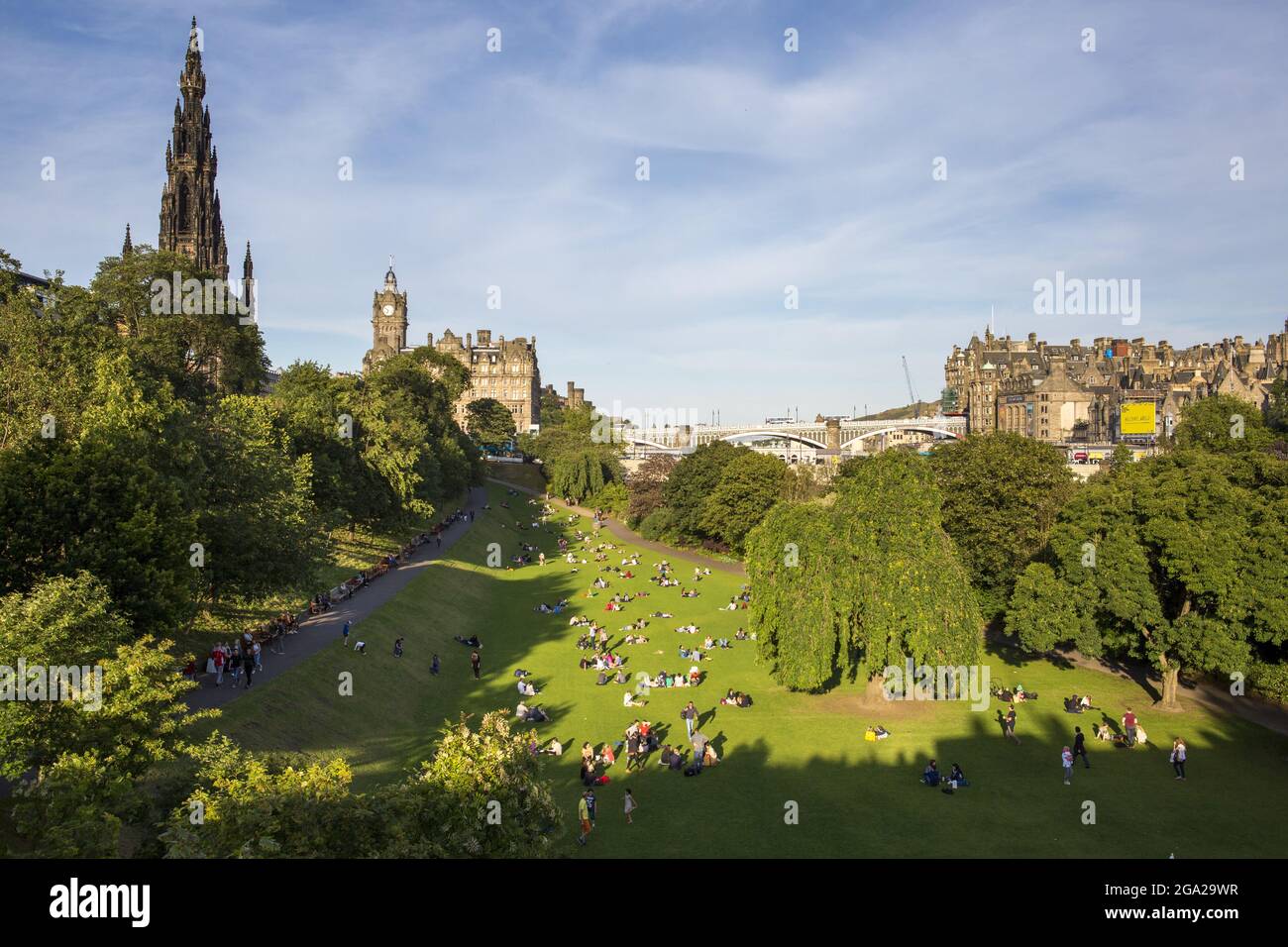 City goers sit in the Princes Street Gardens in downtown Edinburgh, Scotland; Edinburgh, Scotland Stock Photo
