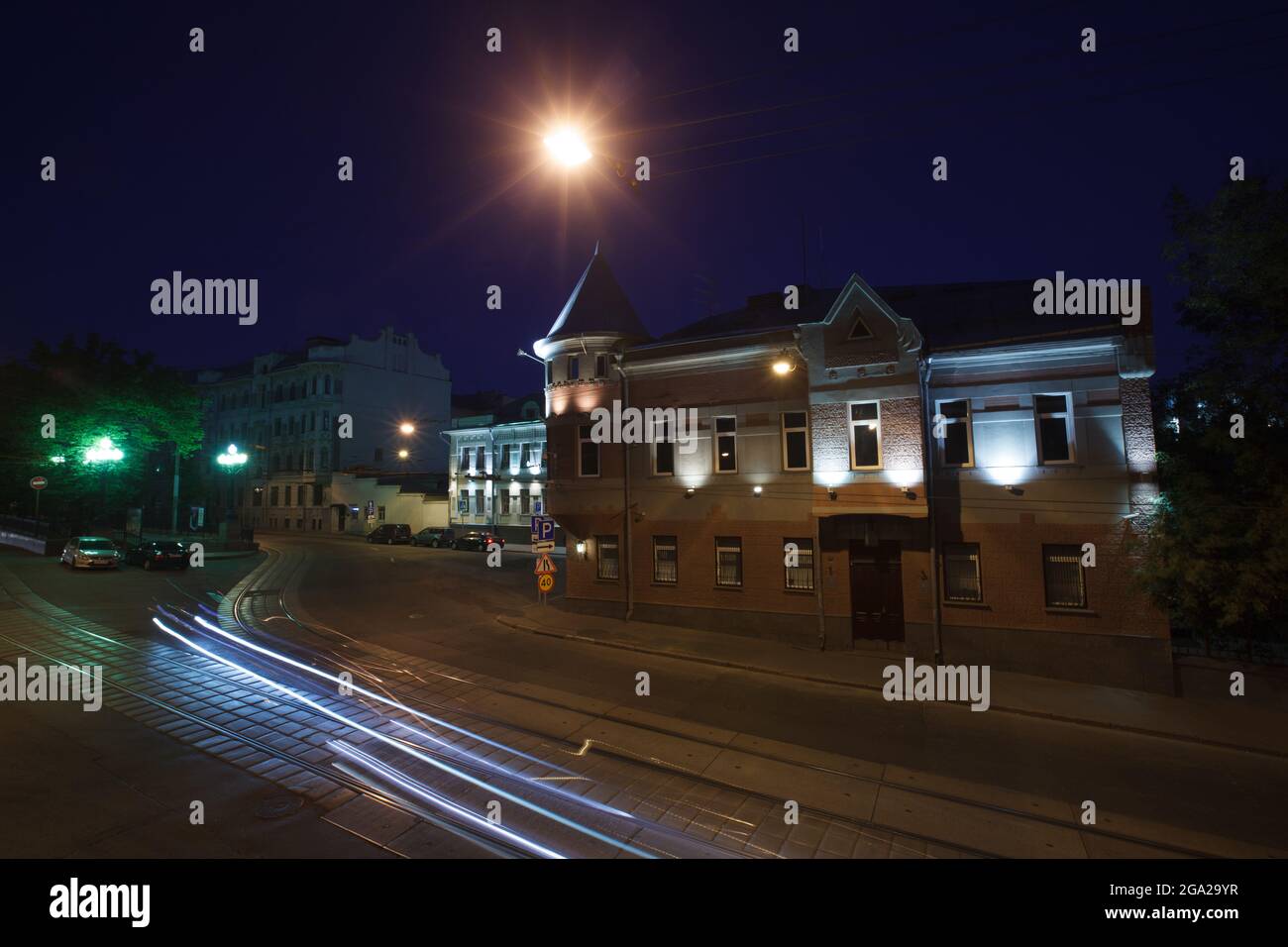 Moscow, Russia - July, 27 2014: Historical buildings in Moscow center at night. Mansion on Yauza boulevard. Tram rails and light traces on foreground Stock Photo