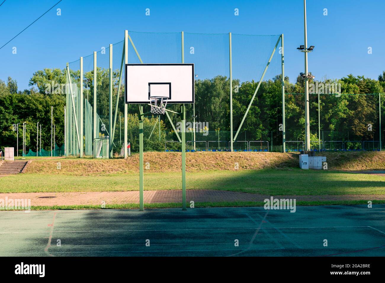 Basketball court in the evening sun. Another sprotrs field (football