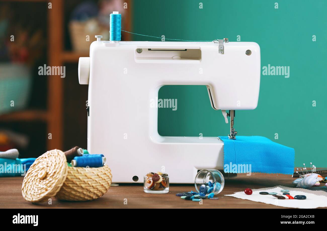 Sewing machine on table in Stock Photo Alamy