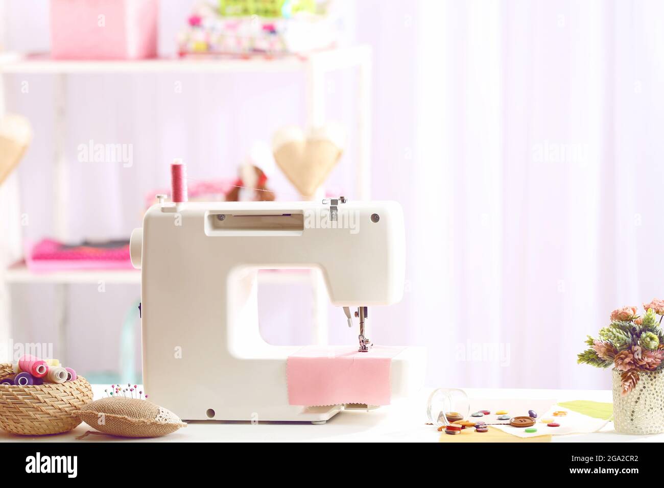 Sewing machine on table in Stock Photo Alamy