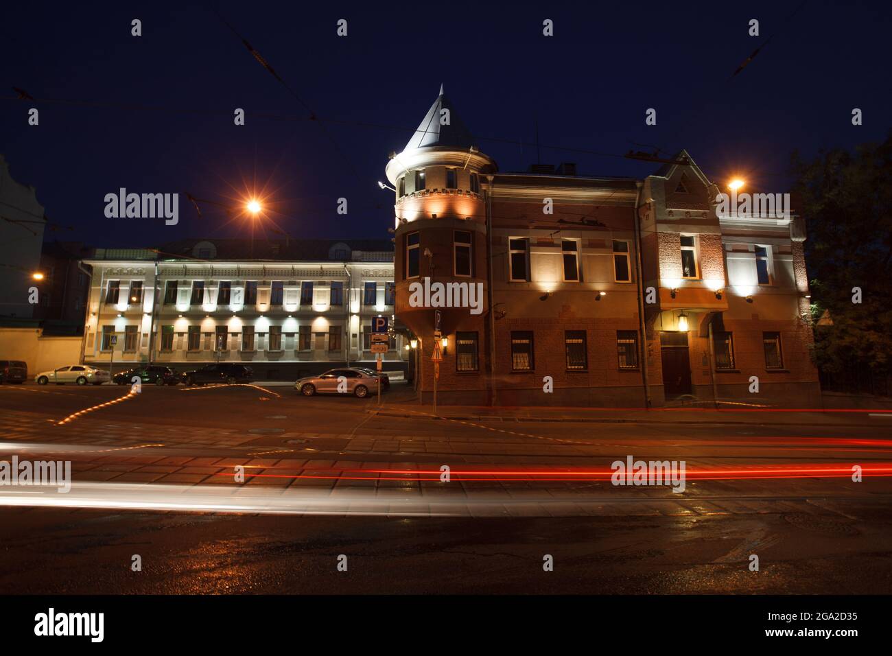 Moscow, Russia - July, 27 2014: Historical buildings in Moscow center at night. Mansion on Yauza boulevard. Tram rails and light traces on foreground Stock Photo