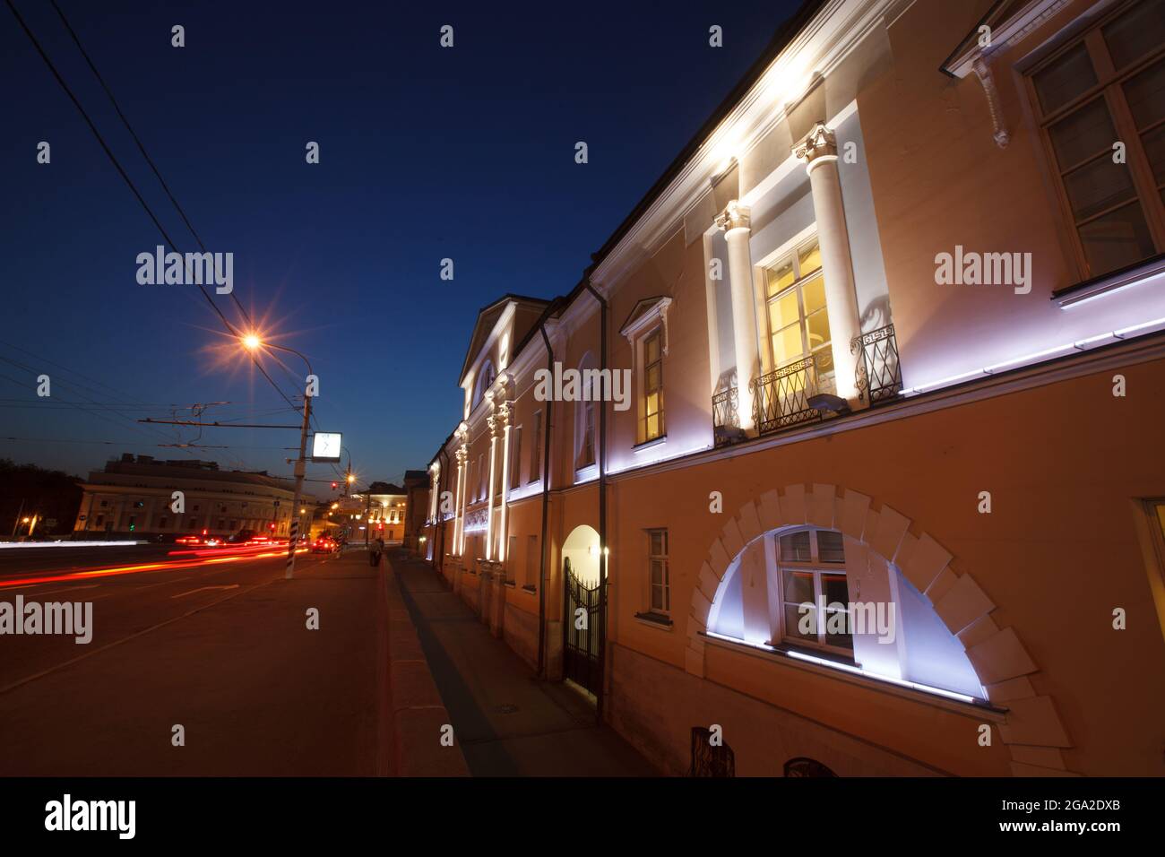 Moscow, Russia - July, 27 2014: Historical building in Moscow center at night. Mansion (right) and road with traces of lights (left) Stock Photo