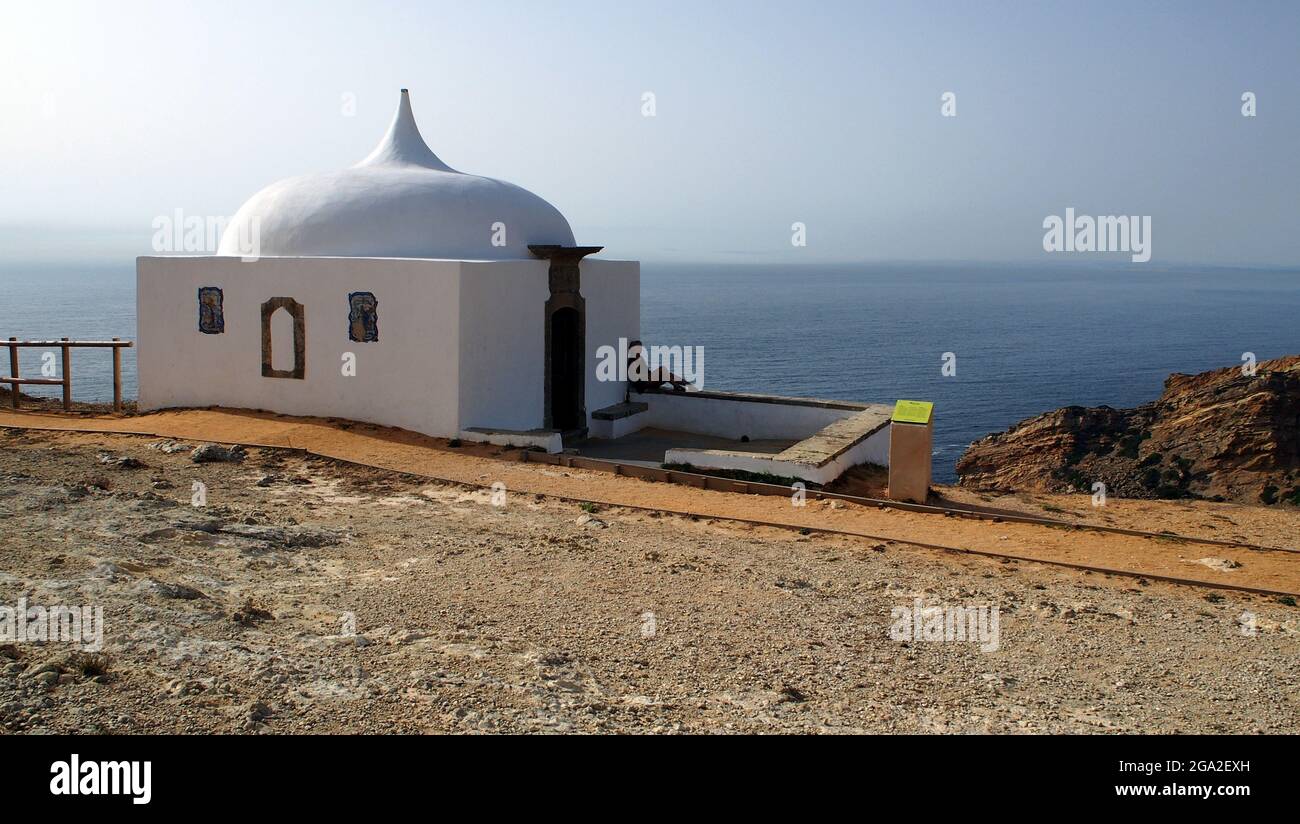 Memory Hermitage, Ermida da Memoria, white chapel with a pointed dome, on the edge of a coastal cliff, Cabo Espichel, Portugal Stock Photo