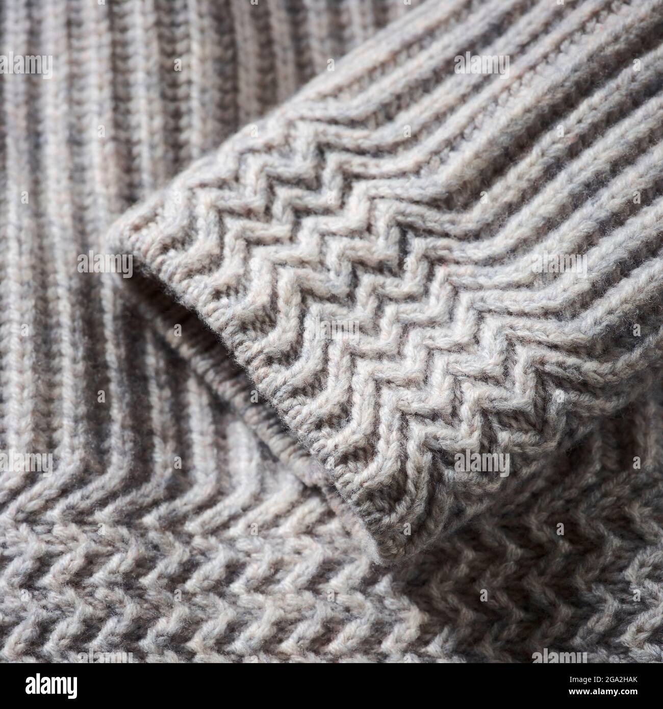 Extreme close-up of the cuff of a grey knit sweater; Studio Stock Photo