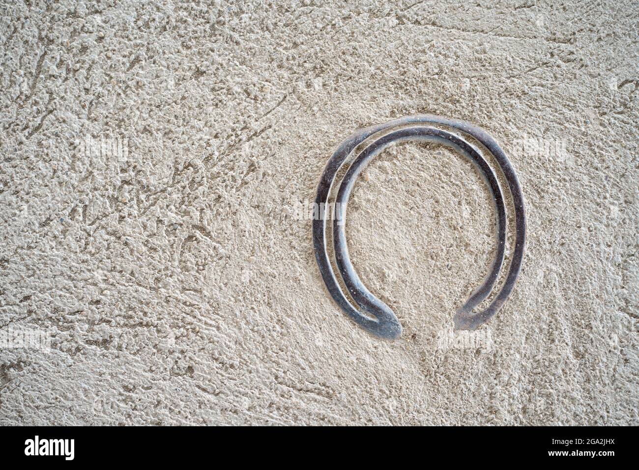 Silver horseshoe on a rock surface Stock Photo Alamy