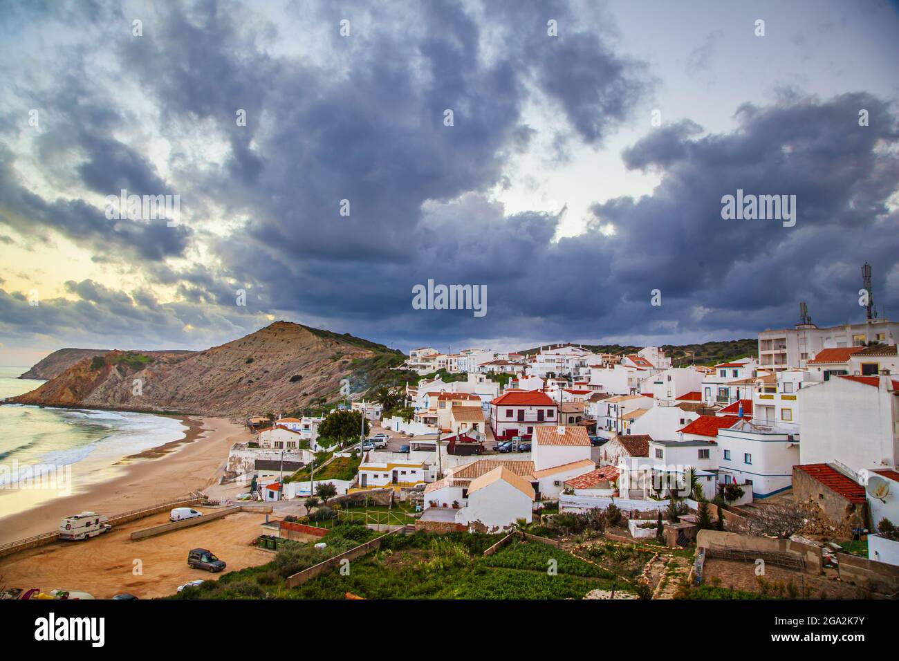 Dramatic grey cloud formation swirling above the traditional fishing village of Burgau in the municipality of Vila do Bispo in the Western Region o... Stock Photo