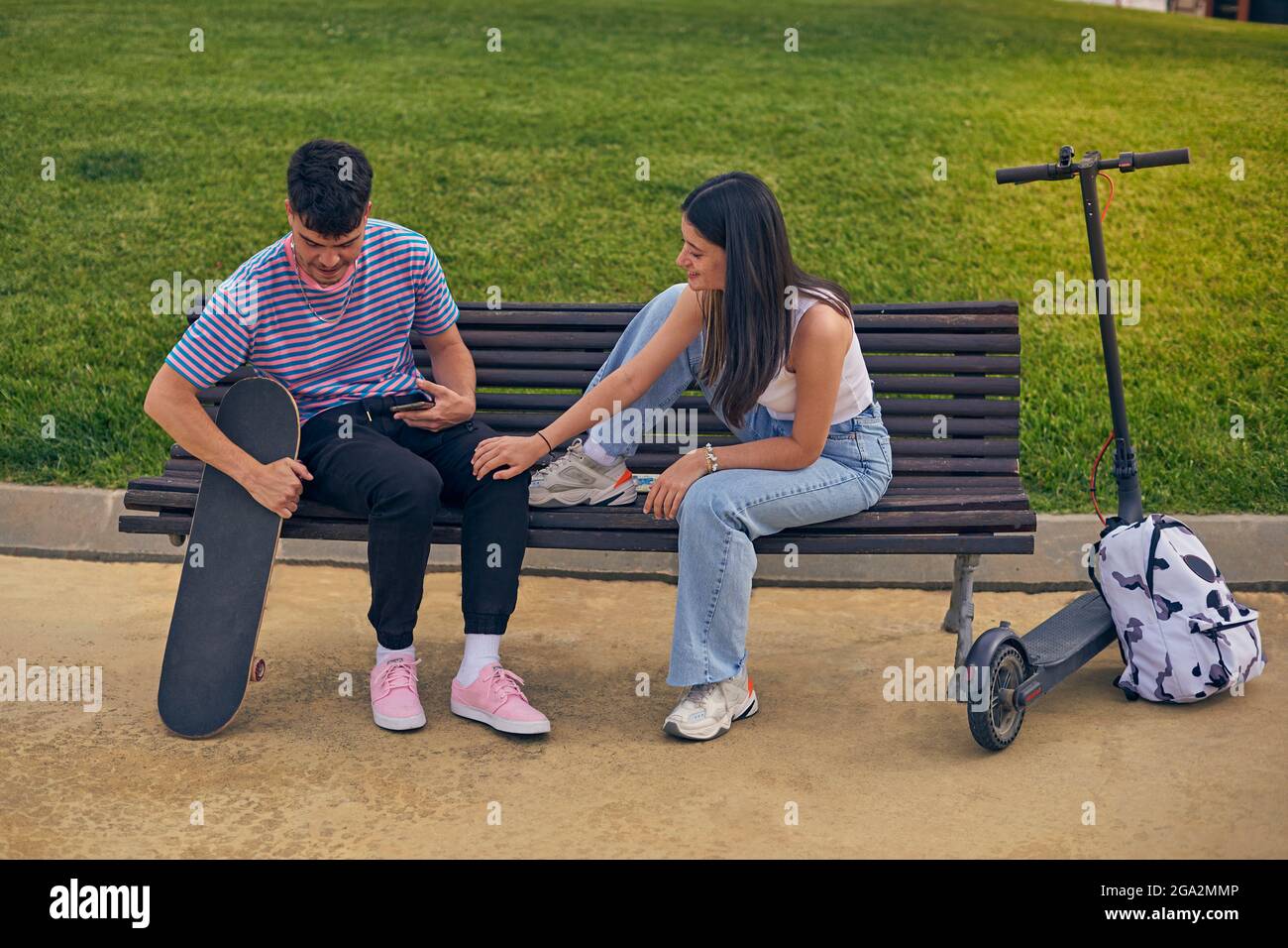 Young couple in park with tecnology Stock Photo