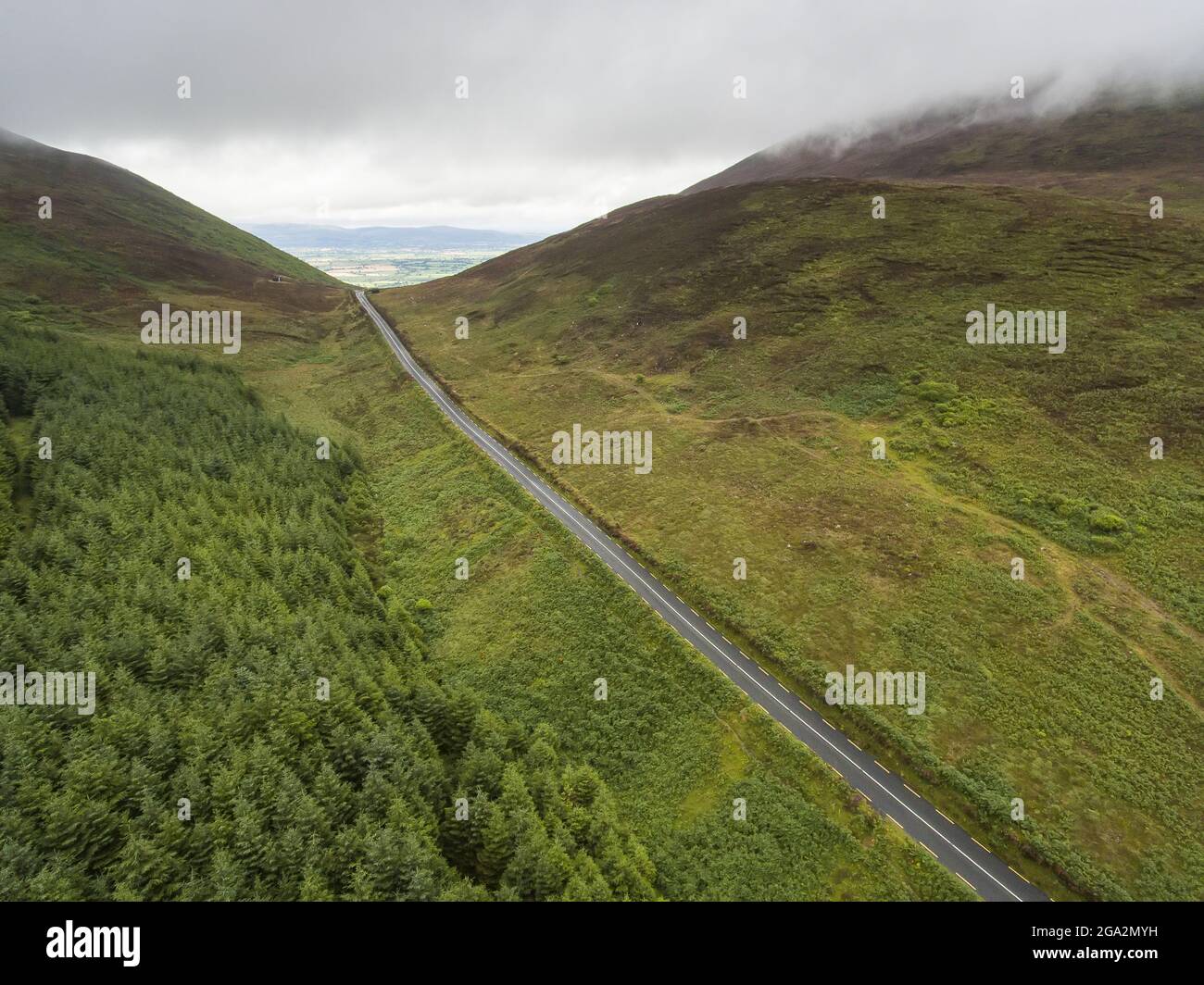 Aerial View of the scenic drive along the road known as The Vee with its forested green mountains; County Waterford, Ireland Stock Photo