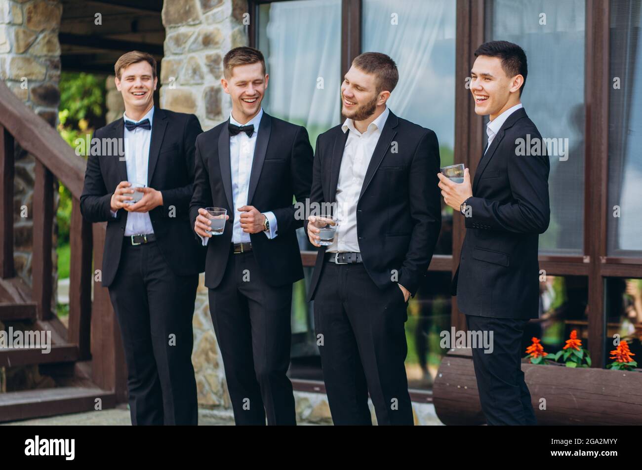 The groom and his friends celebrate the wedding. Men in suits. Mens
