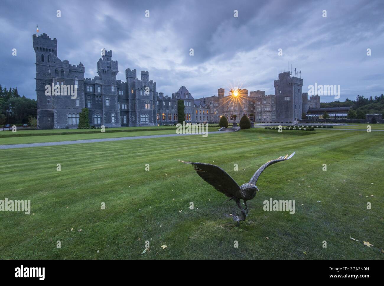 Falcon sculpture and grounds at nighttime at Ashford Castle, a 13th century castle turned into a 5 star luxury hotel; Cong, County Mayo, Ireland Stock Photo