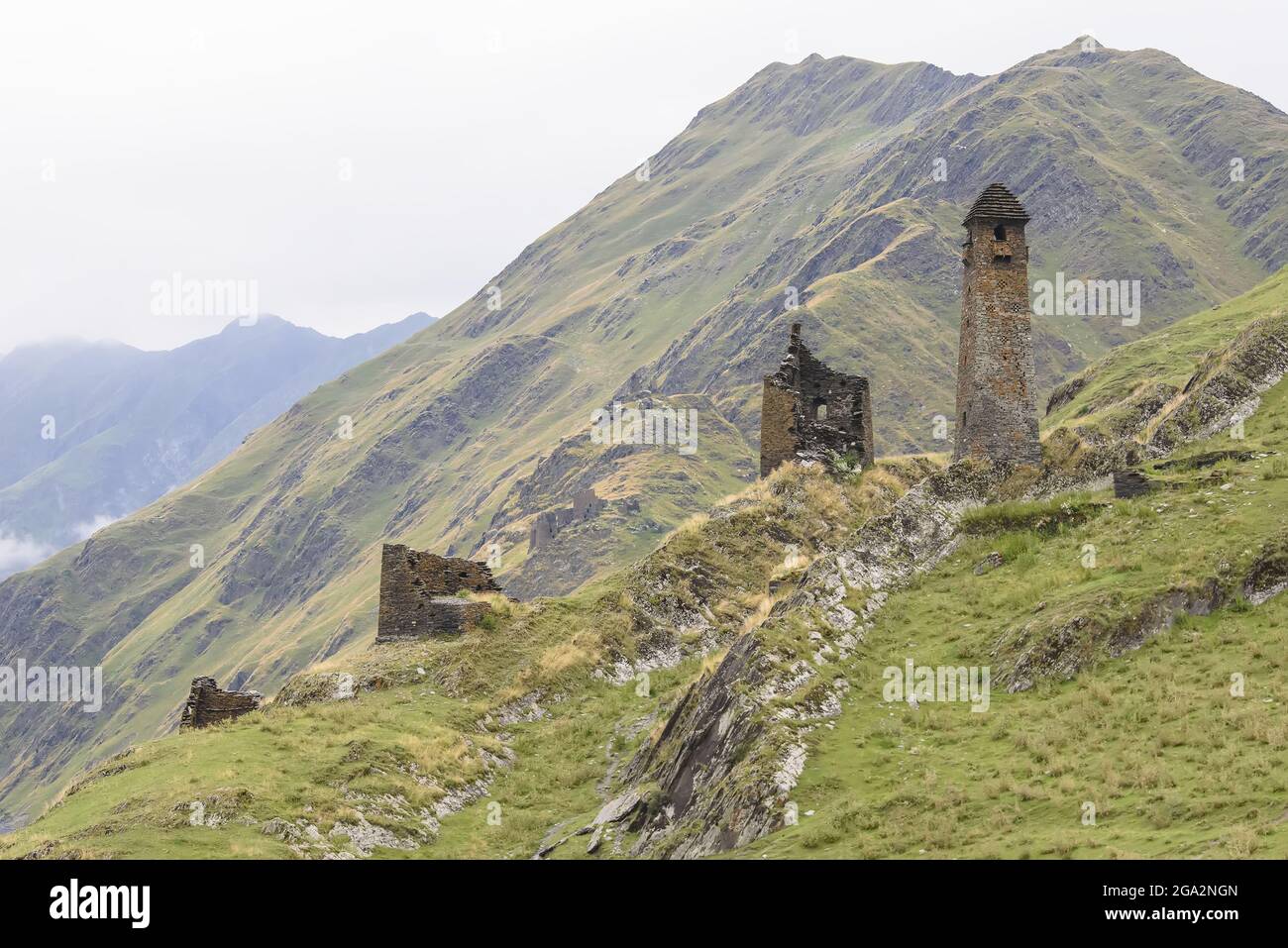 The ruins of the abandoned stone watch towers in the mountainside village of Girevi in the Tusheti National Park; Girevi, Kakheti, Georgia Stock Photo