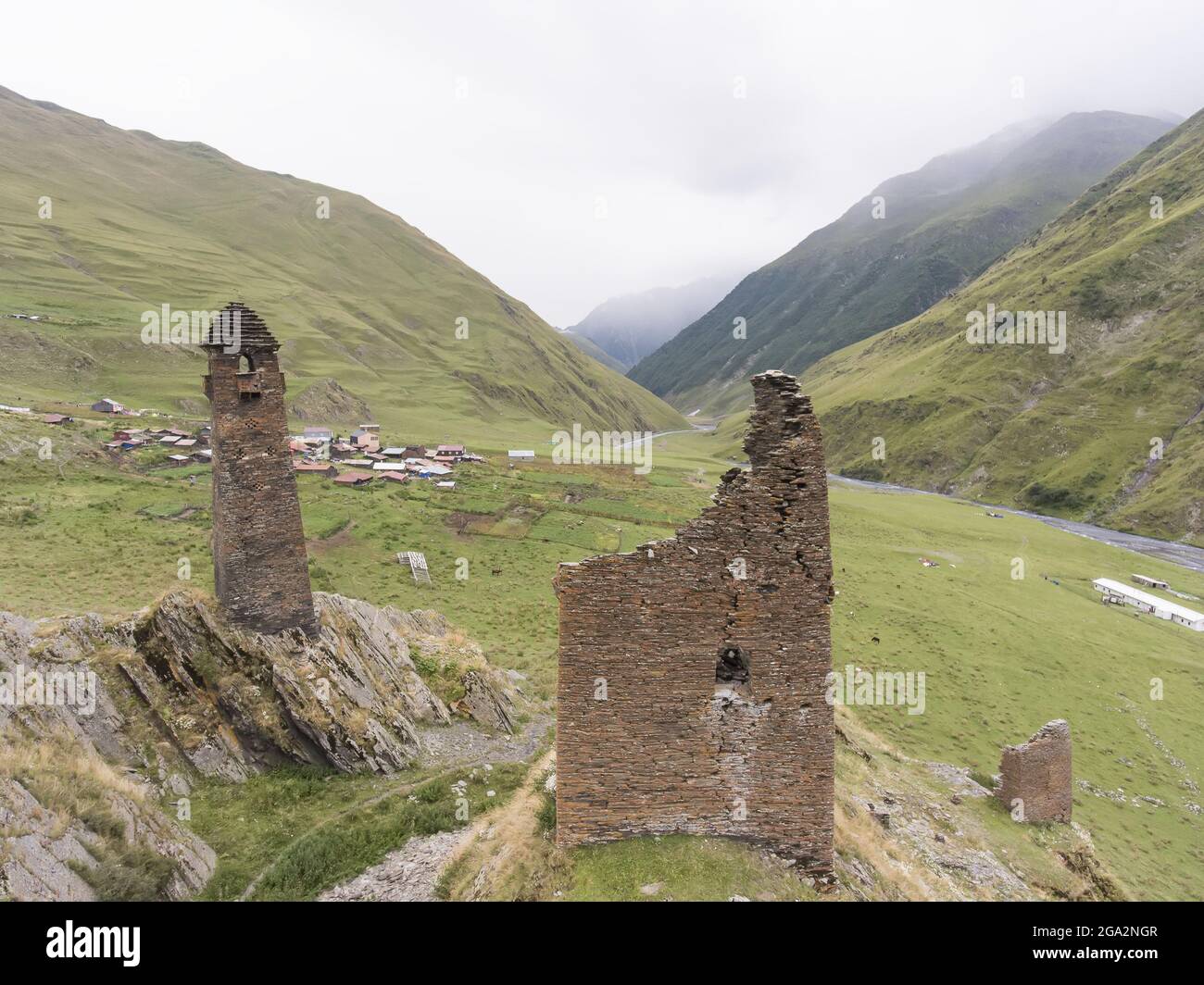 The ruins of the abandoned stone watch towers on the mountainside above the village of Girevi in the Tusheti National Park; Girevi, Kakheti, Georgia Stock Photo