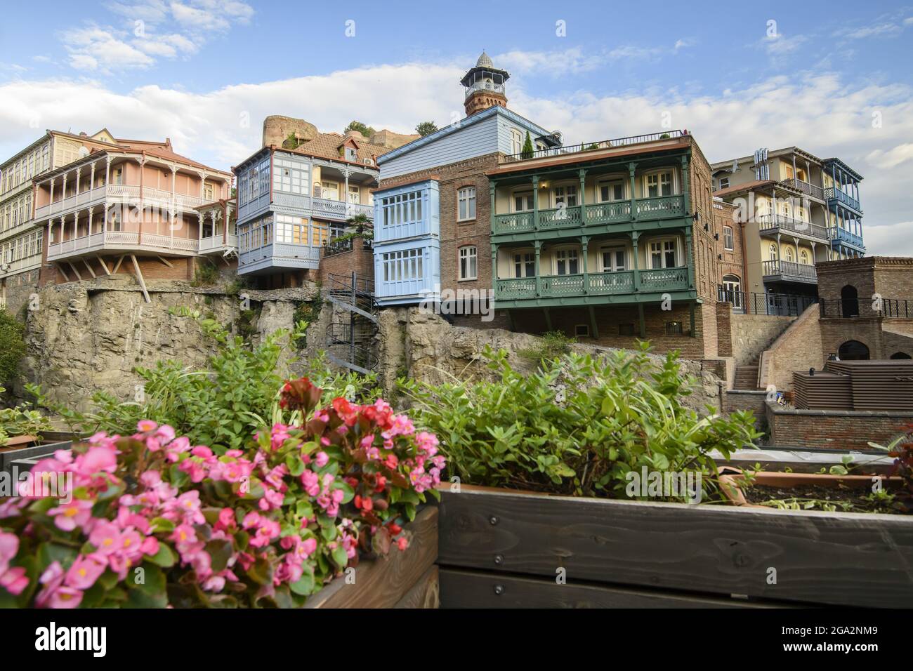 From balconies with flower boxes looking across the Tsavkisi-Tskali River to the old brick buildings with wooden balconies built on the cliffs in L... Stock Photo