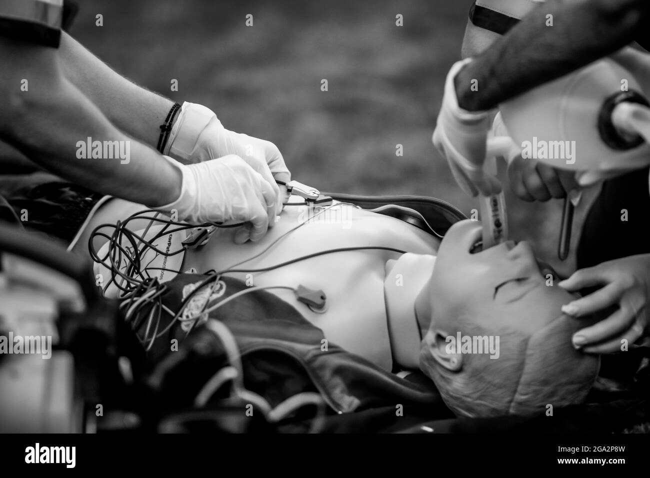 Bucharest, Romania - July 28, 2021: Paramedics perform CPR to a plastic dummy during a public demonstration on how to save a victim. Stock Photo