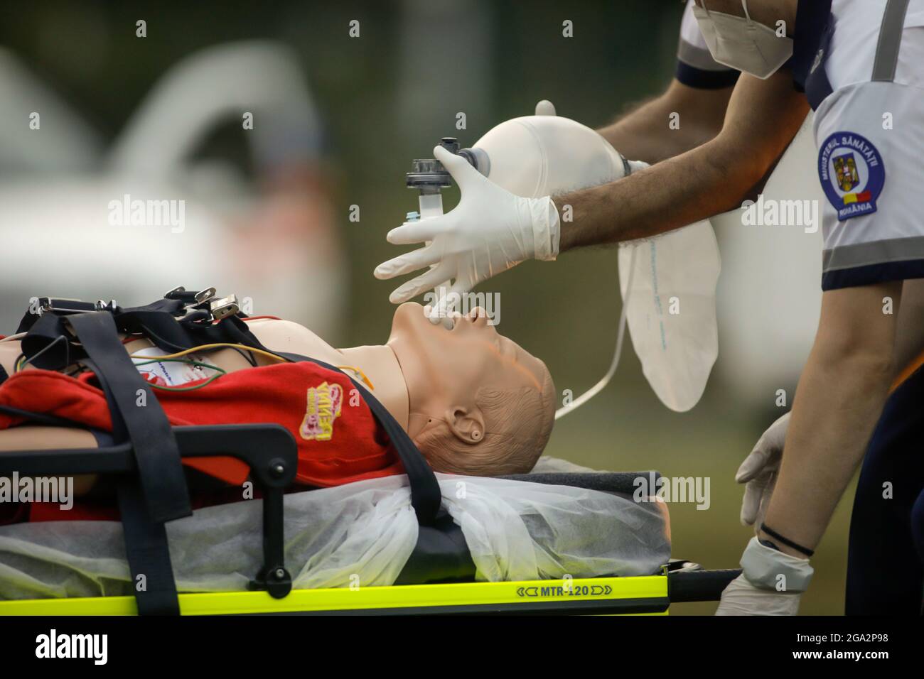 Bucharest, Romania - July 28, 2021: Paramedics perform CPR to a plastic dummy during a public demonstration on how to save a victim. Stock Photo