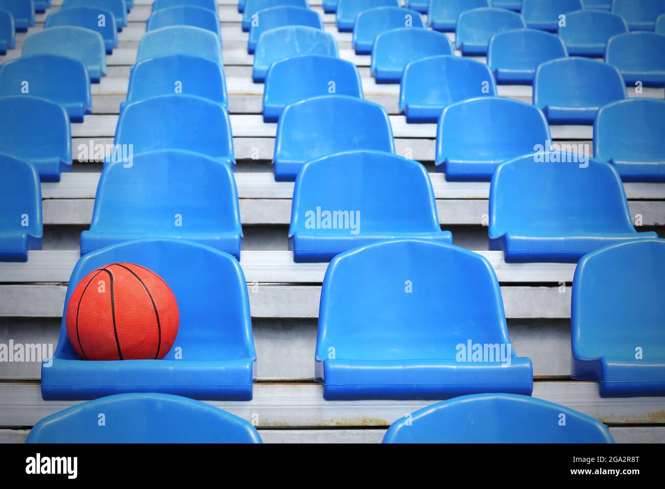 Basketball ball on stadium seat Stock Photo - Alamy