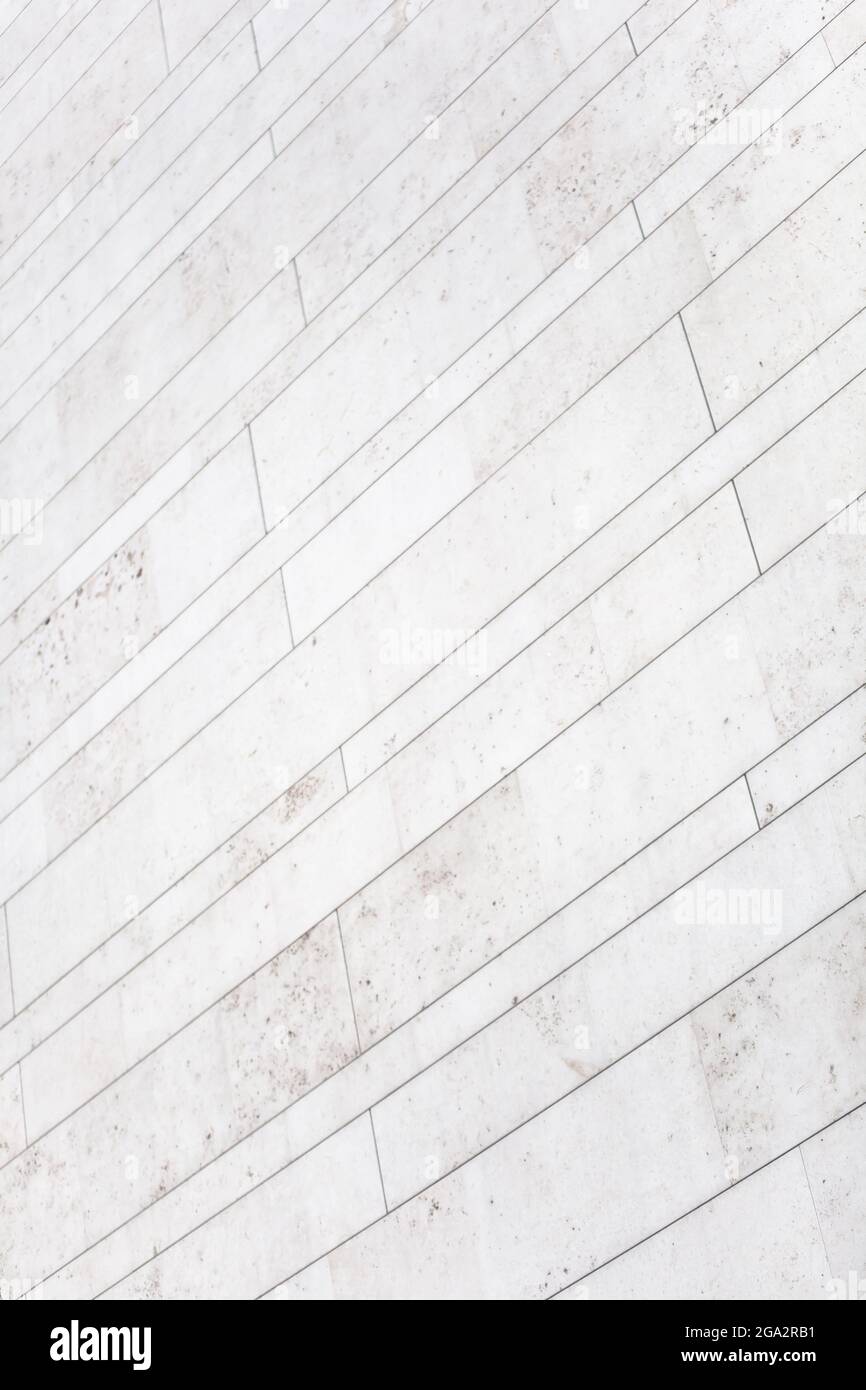 Minimalist white marble wall surface with tiles and parallel lines. Simplicity in modern architecture. Corners and sharp edges Stock Photo