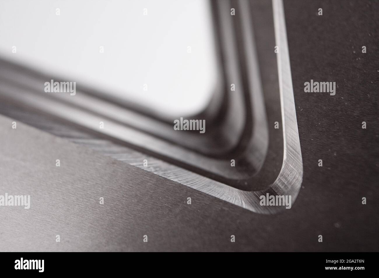 Stainless steel object. Parallel grooves, curves and lines on a ...